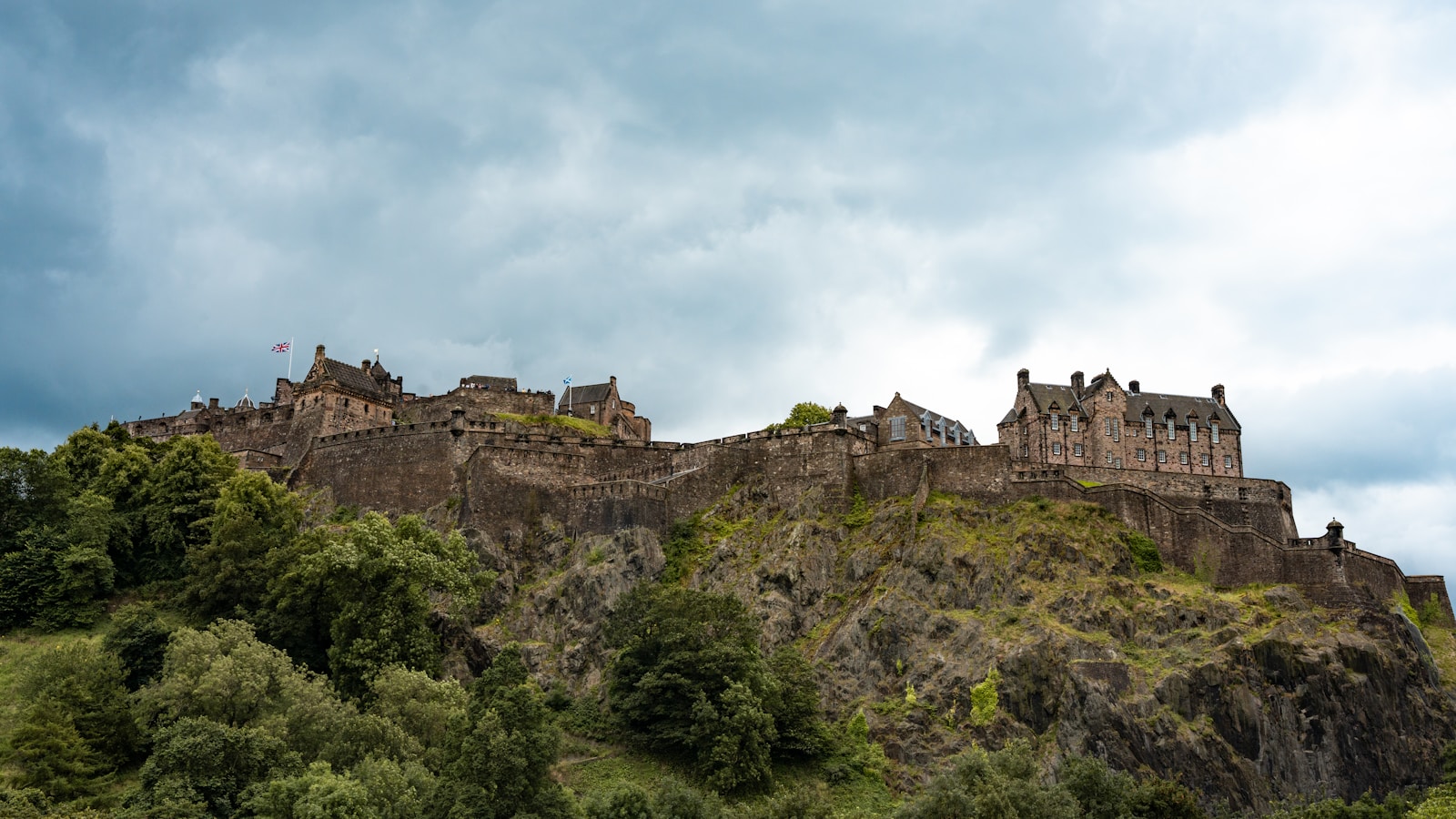 a castle on top of a hill surrounded by trees